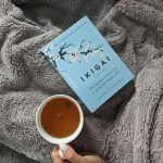 Enjoy a relaxing day with Ikigai and a cup of tea on a soft blanket, perfect for leisure time. sens de la vie