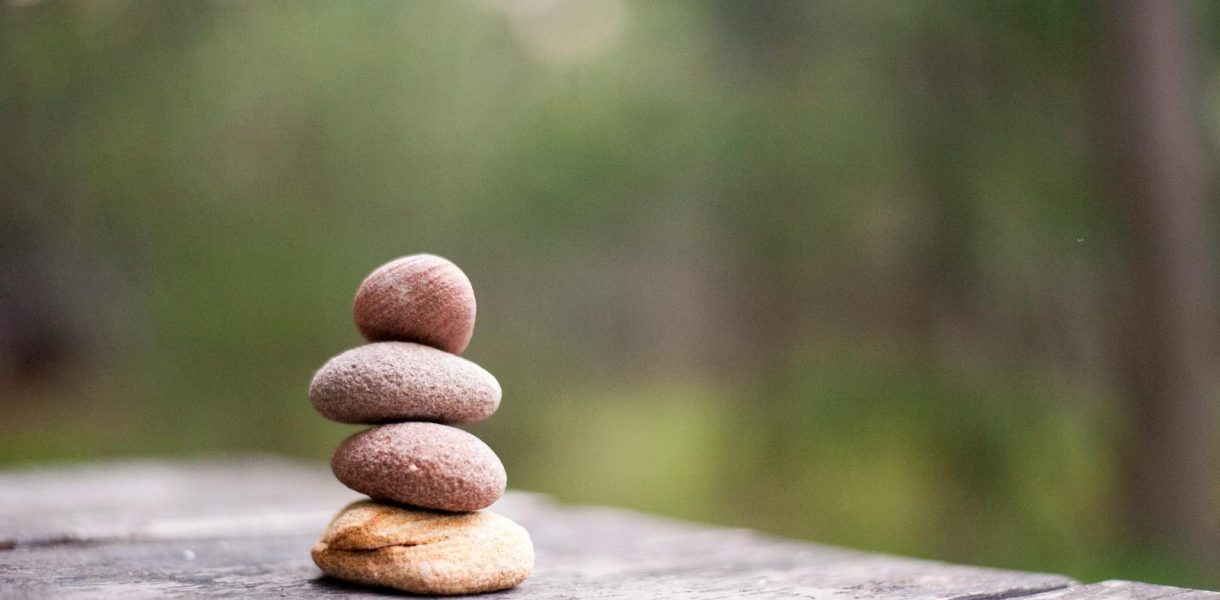 Balance and tranquility embodied by stacked stones in a natural outdoor setting.