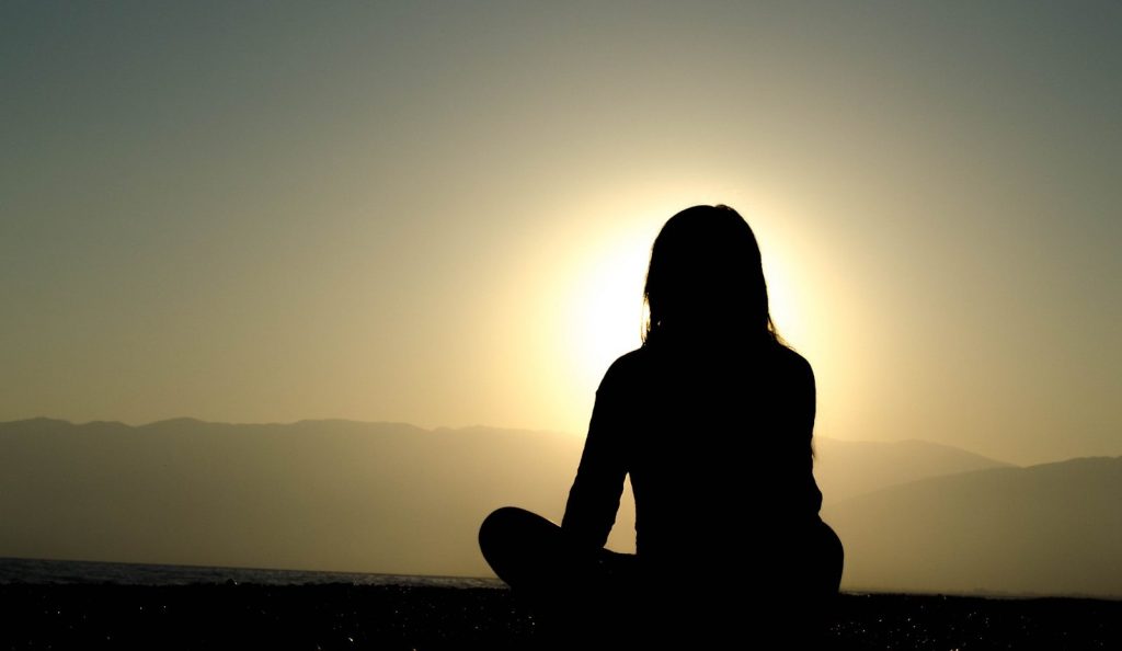 reconnection woman sitting on sand
