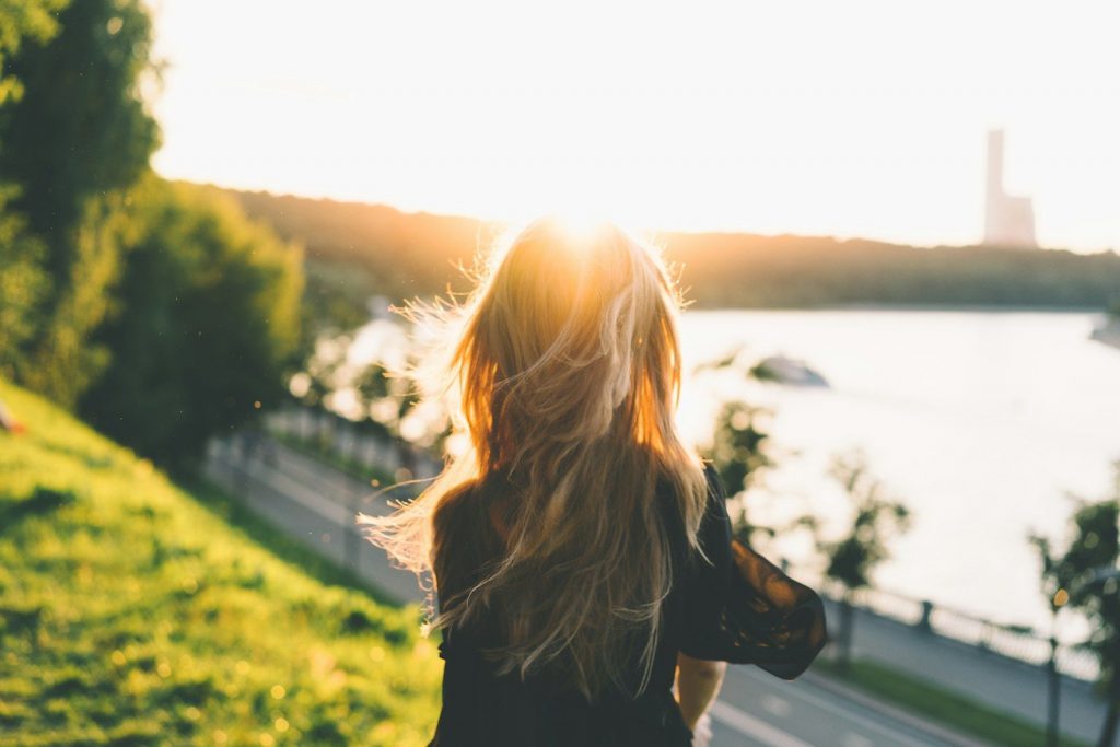 transition 
woman sitting while looking at the sunset